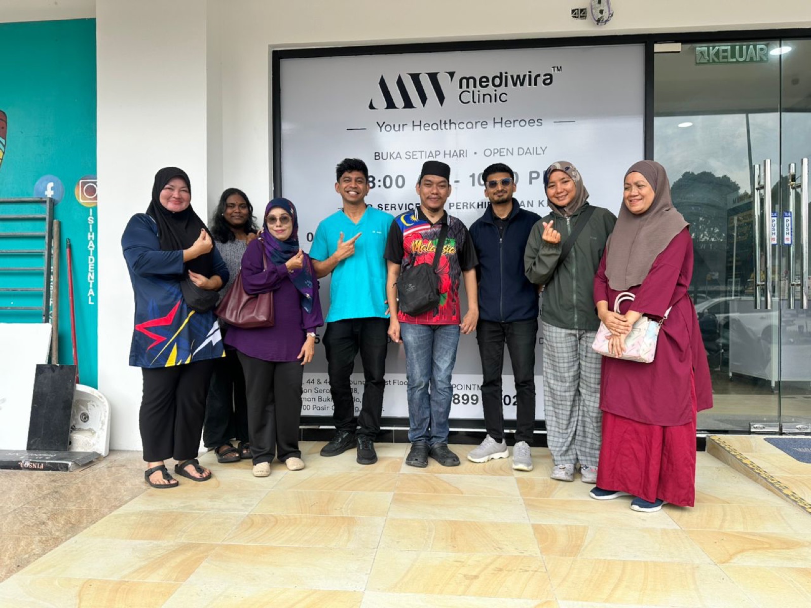 The Mediwira Pasir Gudang team with residents on food aid distribution day